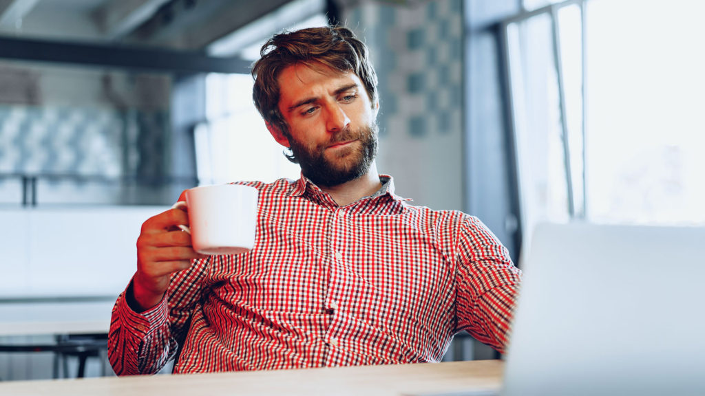A man looking to a computer screen