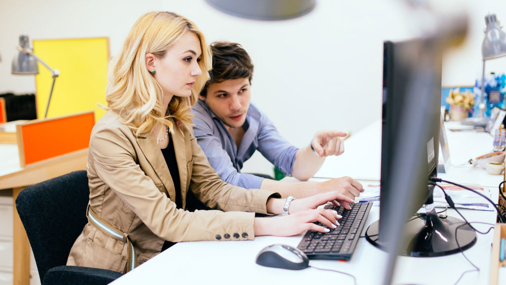 A couple working together in front of a computer