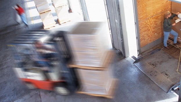 Pallet Stacker running through a wharehouse
