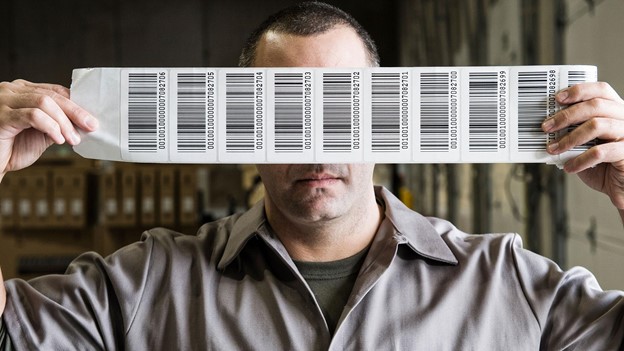 a man holding a series of barcode